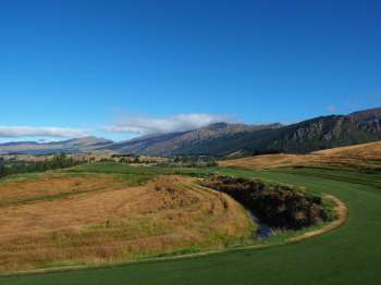 Tee shot from atop water race on the 8th hole 